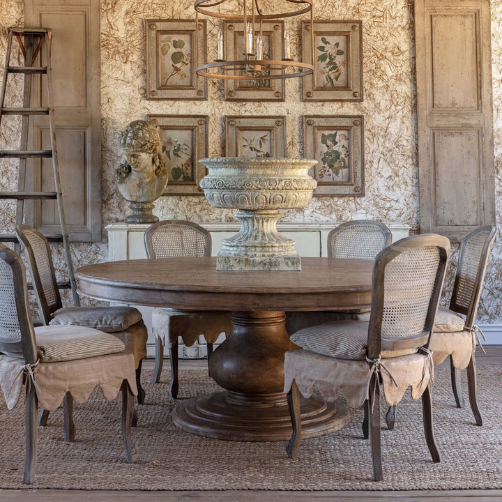 Vintage Farmhouse Round Dining Table with chairs in rustic decor setting, featuring a wooden pedestal base and classic design.