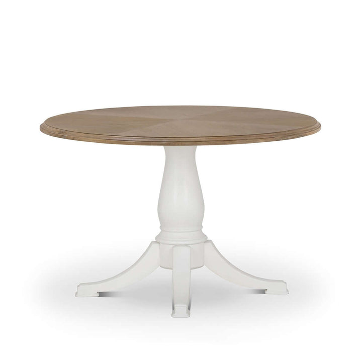 Vintage Farmhouse Round Pedestal Dining Table with rustic wood top and elegant white base, inspired by Cotswold heritage.