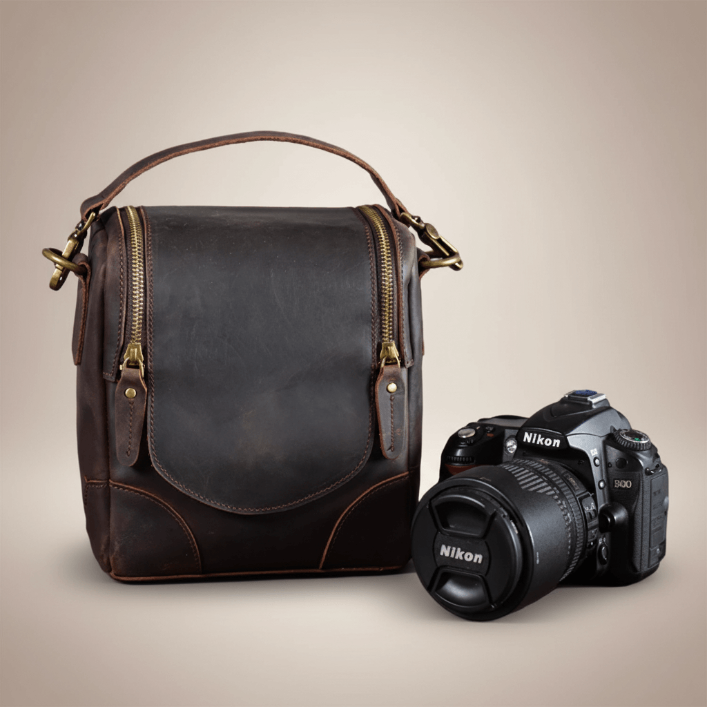 Vintage Full-Grain Leather Camera Bag with DSLR, featuring timeless craftsmanship, known as The Calista, displayed on a neutral background.