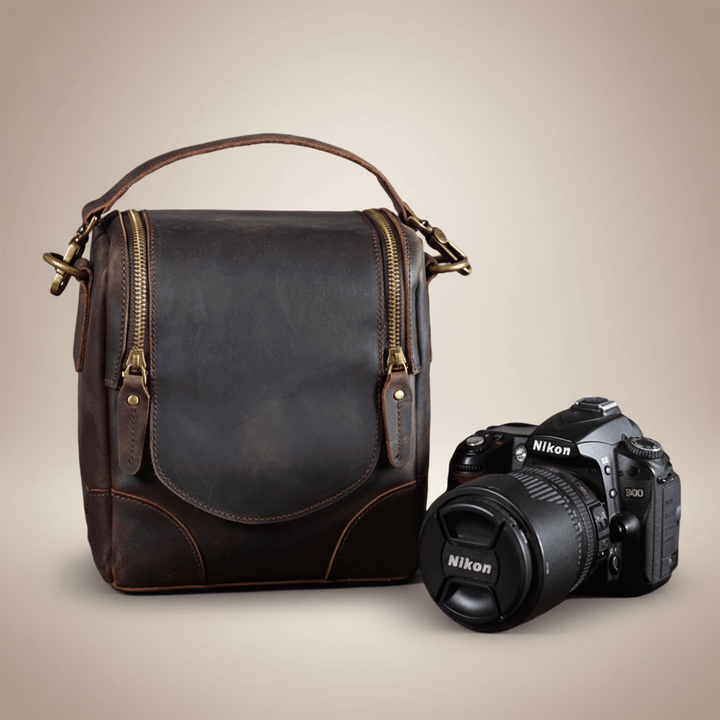 Vintage Full-Grain Leather Camera Bag with DSLR, featuring timeless craftsmanship, known as The Calista, displayed on a neutral background.