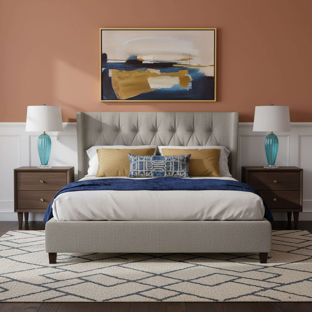 Neatly made bed with decorative pillows in a bedroom setting.