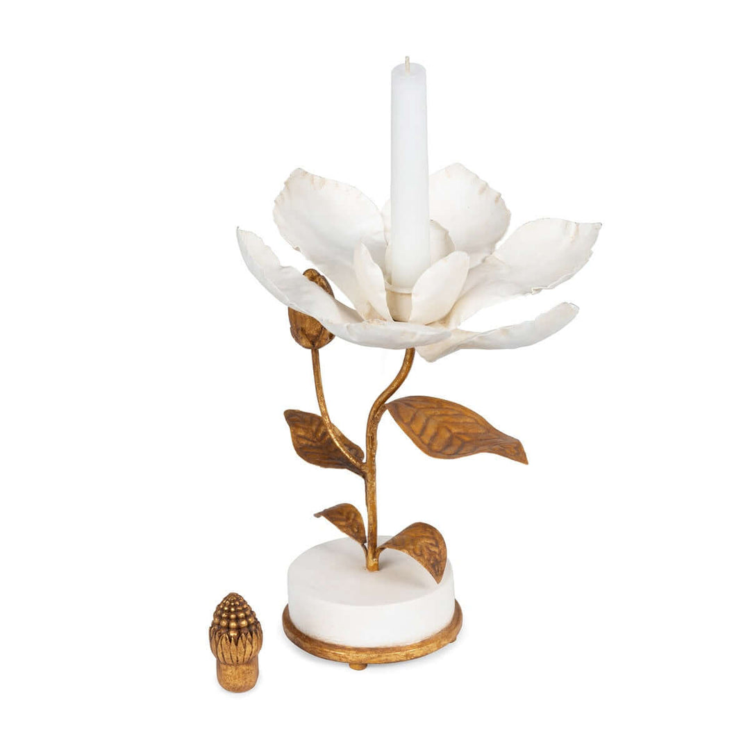 Vintage Gold Magnolia Candle Holder with ivory petals and gold accents, positioned on a smooth white base with artistic floral design.