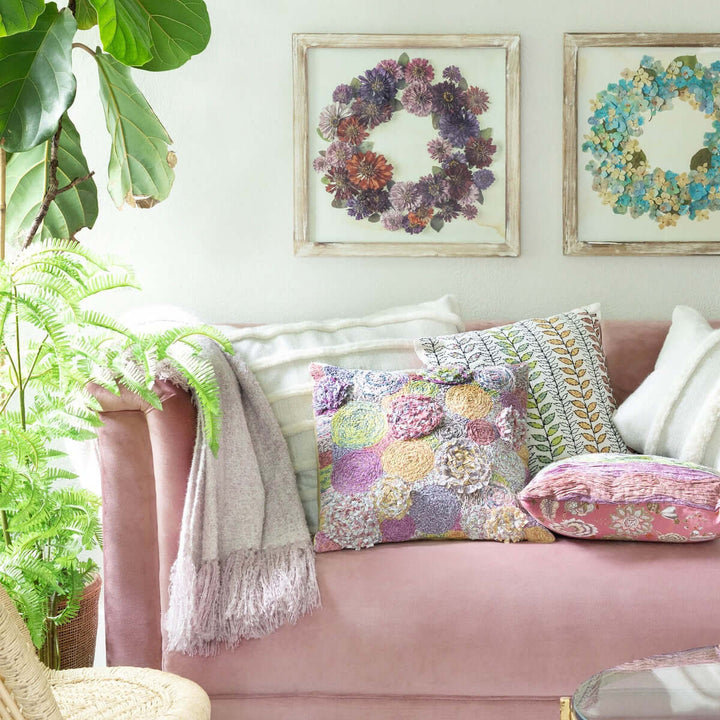 Vintage Light Blush Boucle Alpaca Wool Throw Blanket draped over pink sofa in cozy living room with floral cushions and framed art.