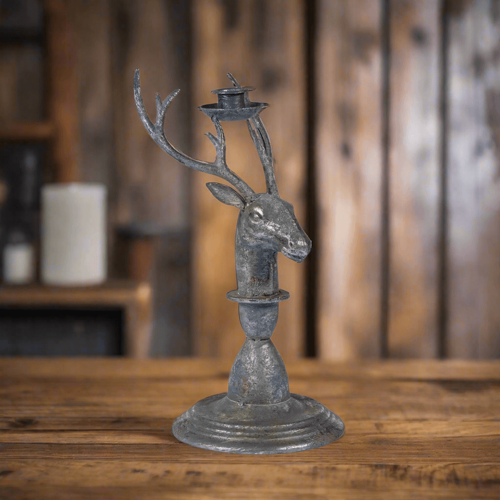 Vintage rustic deer antler candle holder with stag head on wooden table, featuring weathered metal finish for home decor.