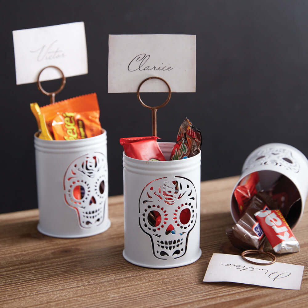 Vintage sugar skull metal place card holder with Halloween theme and sweets, ideal for festive table decor.