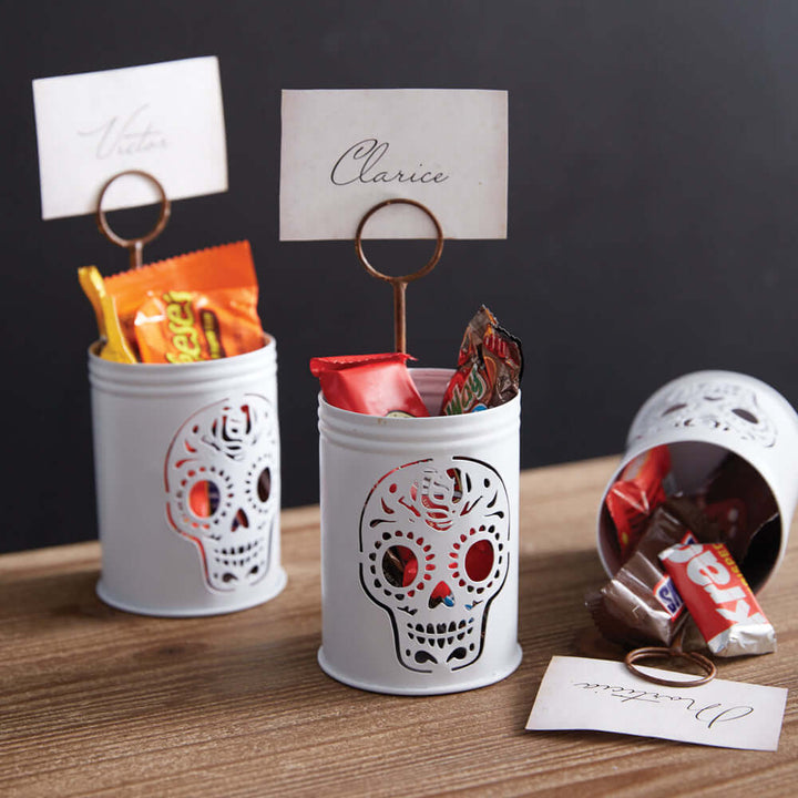 Vintage sugar skull metal place card holder with Halloween theme and sweets, ideal for festive table decor.
