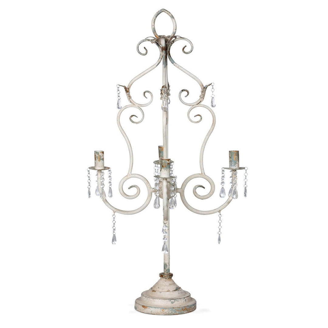 Vintage tabletop chandelier with crystals and distressed white finish, adding romantic elegance with curves and sparkling accents.