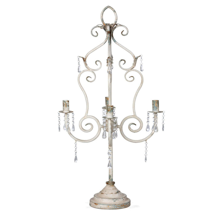 Vintage tabletop chandelier with crystals and distressed white finish, adding romantic elegance with curves and sparkling accents.