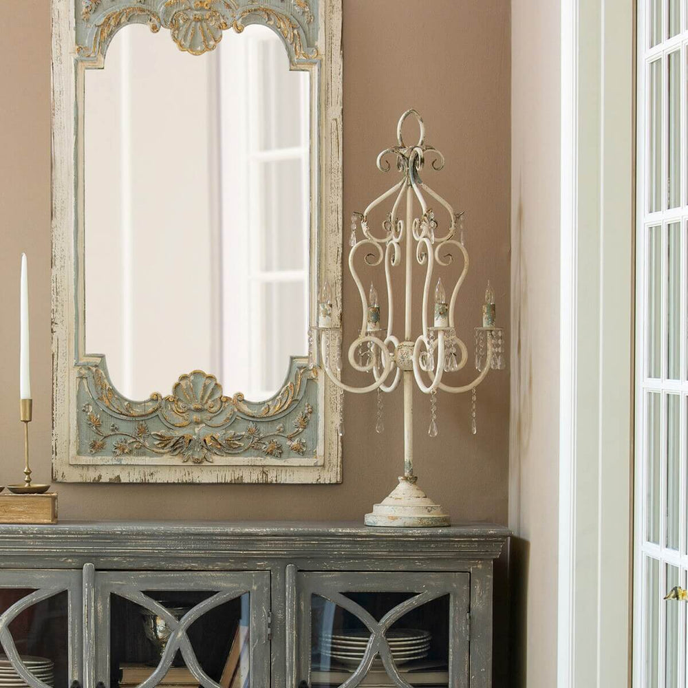 Vintage tabletop chandelier with crystals adds elegance, featuring distressed finish, antique styling, and ornate curves on a sturdy base.