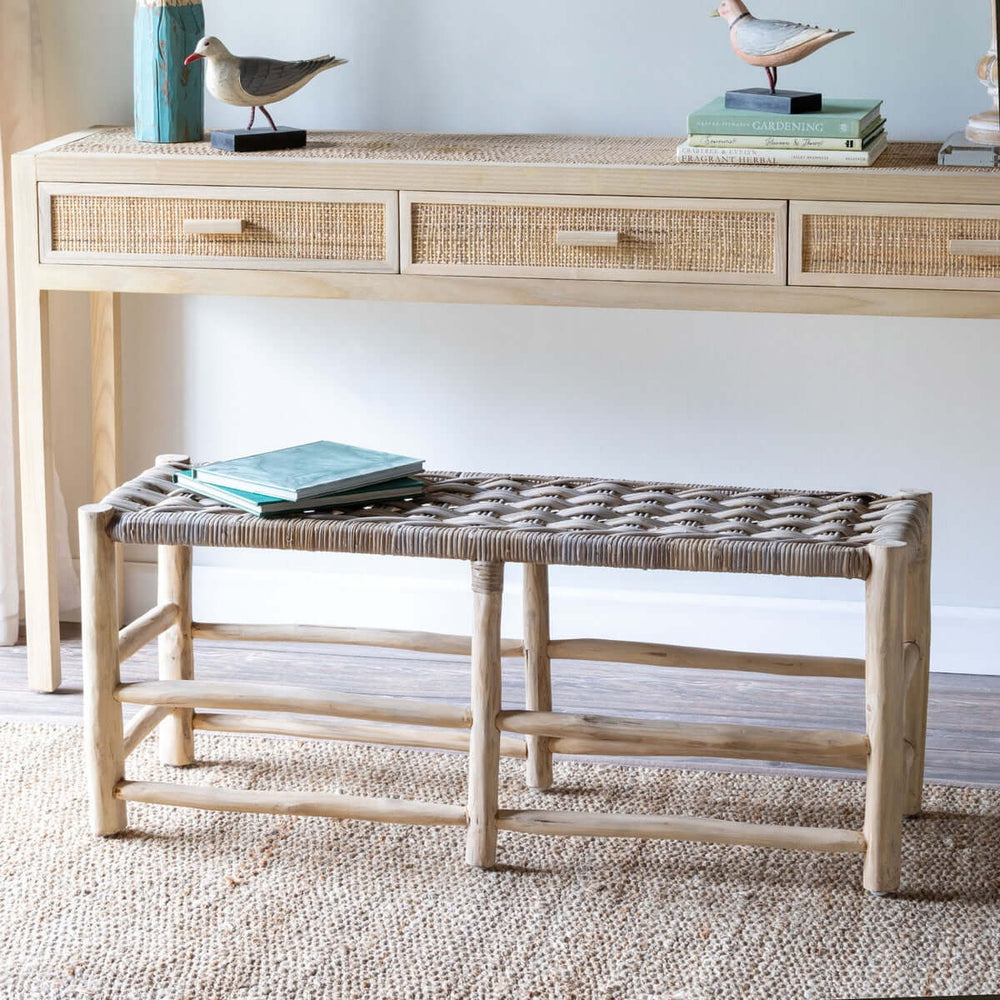 Vintage Teak and Rattan Entryway Bench with handwoven rattan top, placed in a cozy room next to a wicker console table. Ideal for home decor.