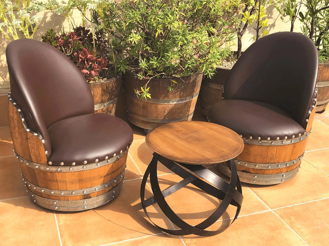 Vintage Whiskey Barrel Chair set with a round wooden table on a patio, showcasing reclaimed barrel wood and rustic design.