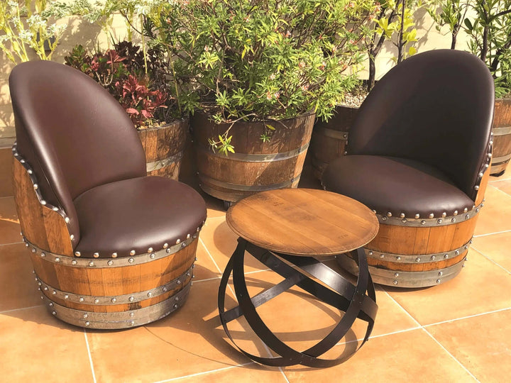 Vintage Whiskey Barrel Chair set with a round wooden table on a patio, showcasing reclaimed barrel wood and rustic design.