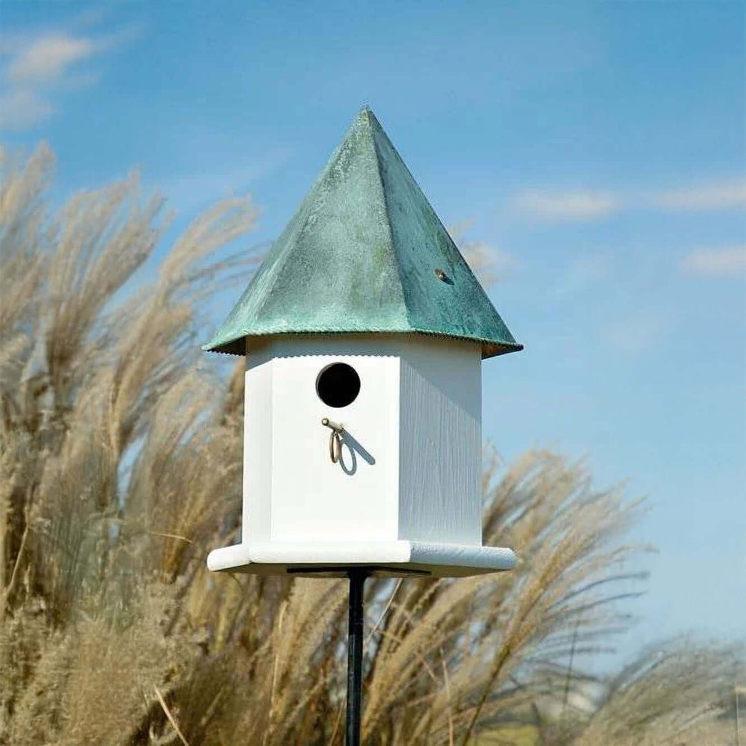 Vintage White Octagonal Bird House with Copper Roof in garden setting with grasses.