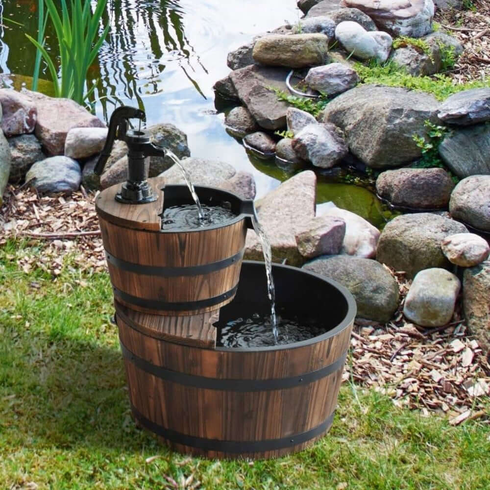 Vintage Wooden Barrel Water Fountain in a rustic garden setting with dual-tier design and authentic wood finish near a pond.