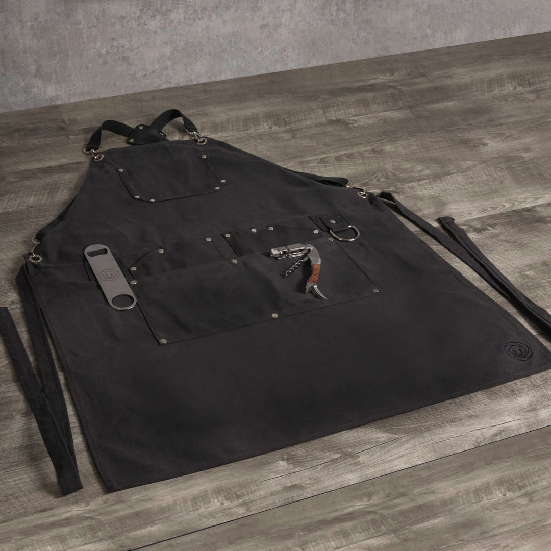 Waxed Canvas Bartender Apron and Tools displayed on wooden surface