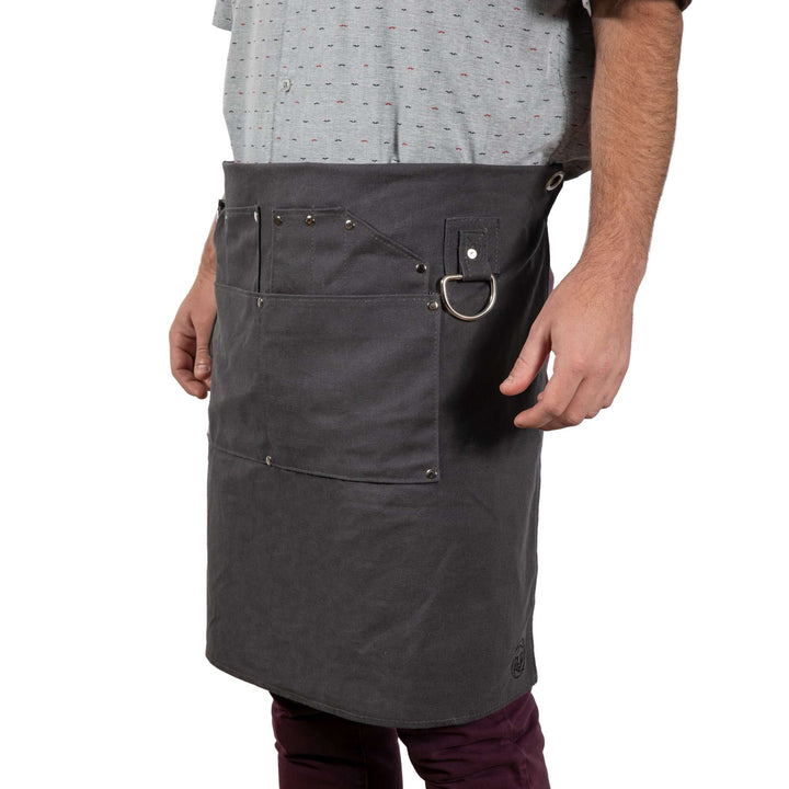 Bartender wearing a Waxed Canvas Bartender Apron and Tools, showcasing durable, professional-grade design for mixology enthusiasts.