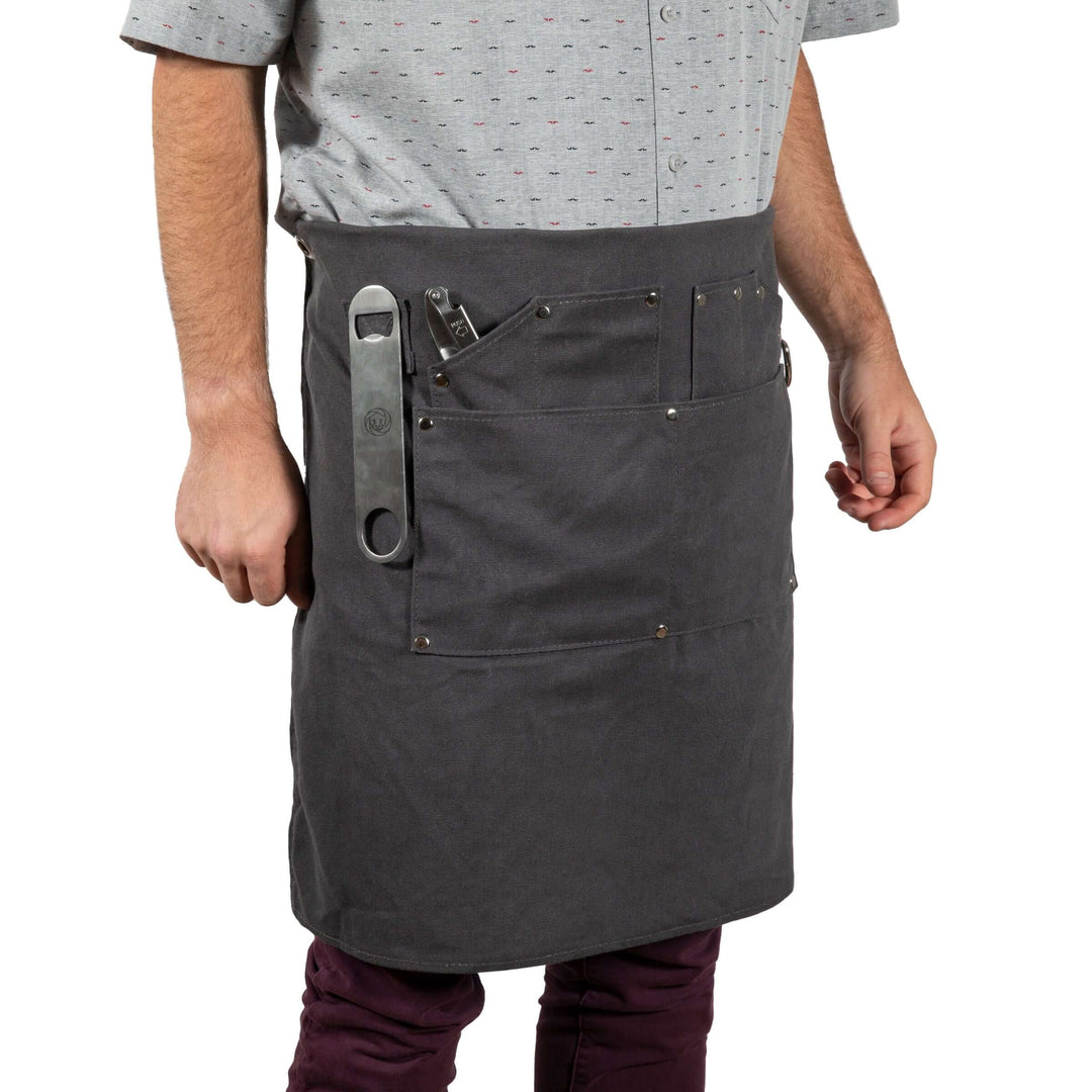 Man wearing Waxed Canvas Bartender Apron and Tools, showcasing durable design for professional mixology use.