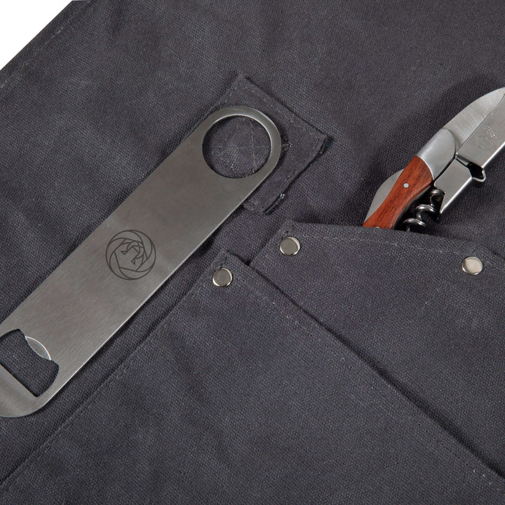 Close-up of Waxed Canvas Bartender Apron and Tools, featuring durable pockets with bottle opener and knife, ideal for professional mixology.