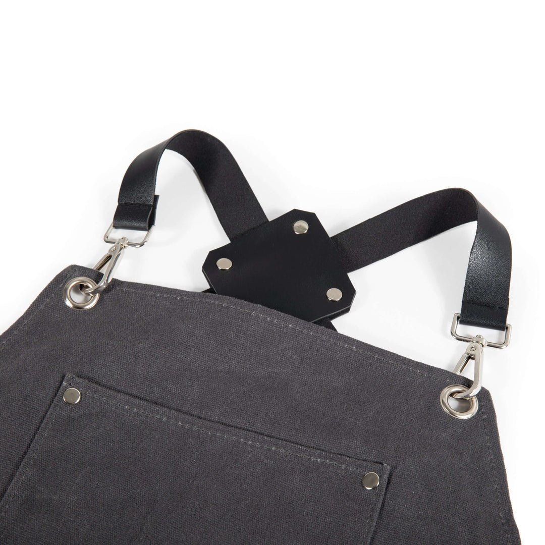 Close-up of Waxed Canvas Bartender Apron showing straps and durable fabric design for mixology professionals.