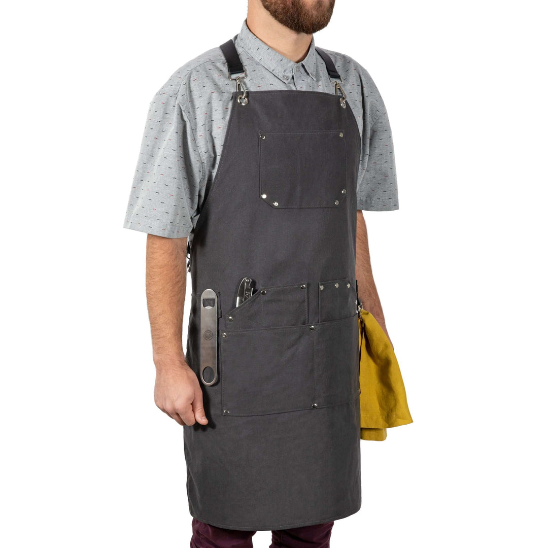 Bartender wearing Waxed Canvas Bartender Apron and Tools with pockets and towel, ideal for professional mixology, durable design