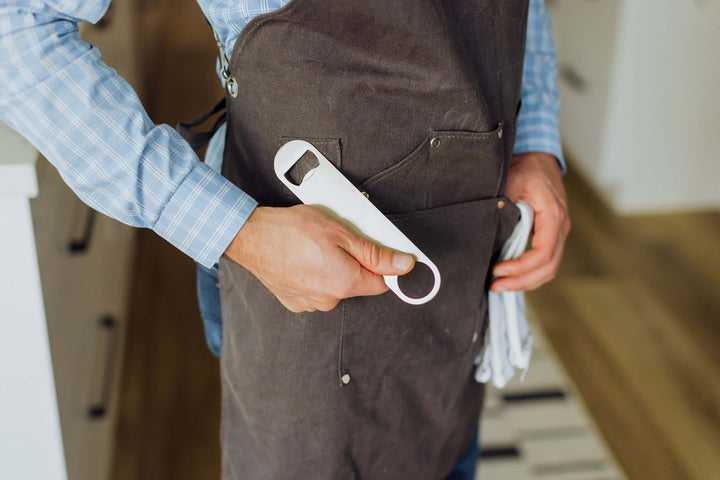 Person wearing Waxed Canvas Bartender Apron and Tools with bottle opener