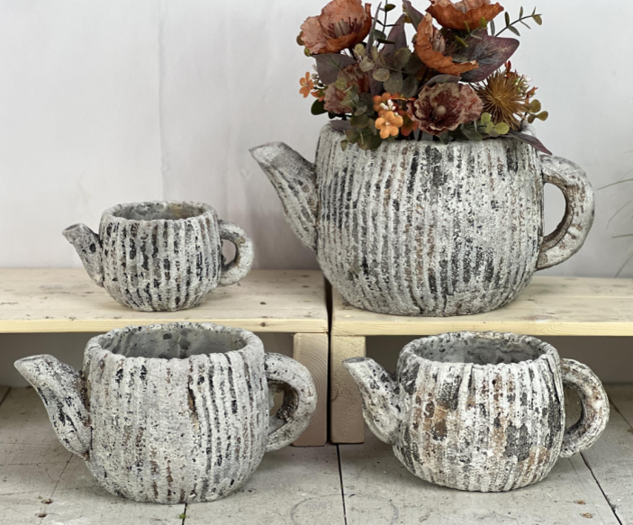 Close view of the weathered cement teapot surface