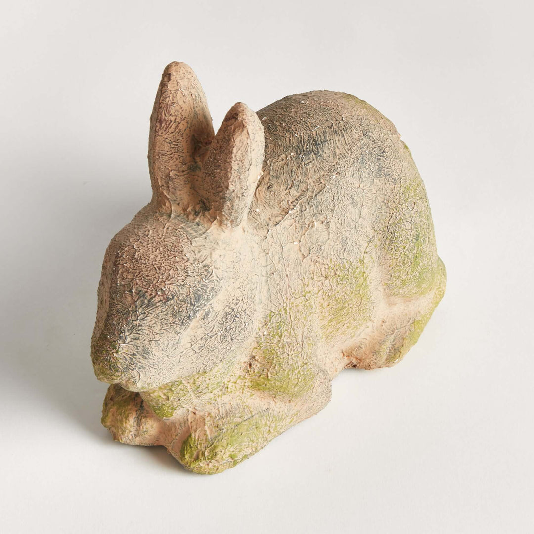 Weathered moss terracotta bunny garden statue, showcasing vintage charm for outdoor decor.