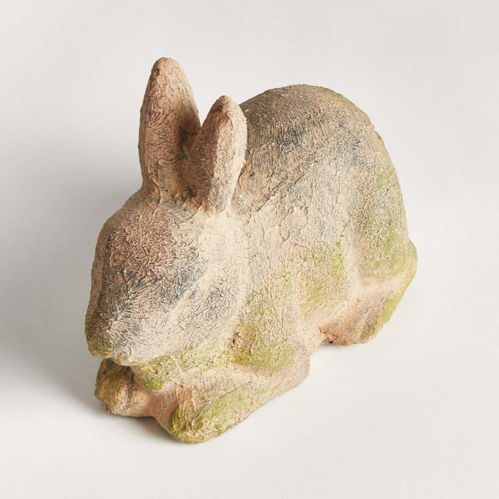 Weathered moss terracotta bunny garden statue, showcasing vintage charm for outdoor decor.