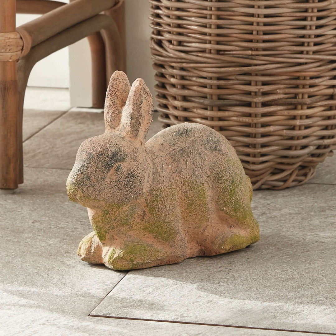 Weathered moss terracotta bunny garden statue, perfect vintage decor for outdoor or indoor spaces.