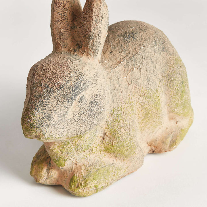 Weathered moss terracotta bunny garden statue, vintage-inspired charm for outdoor decor.
