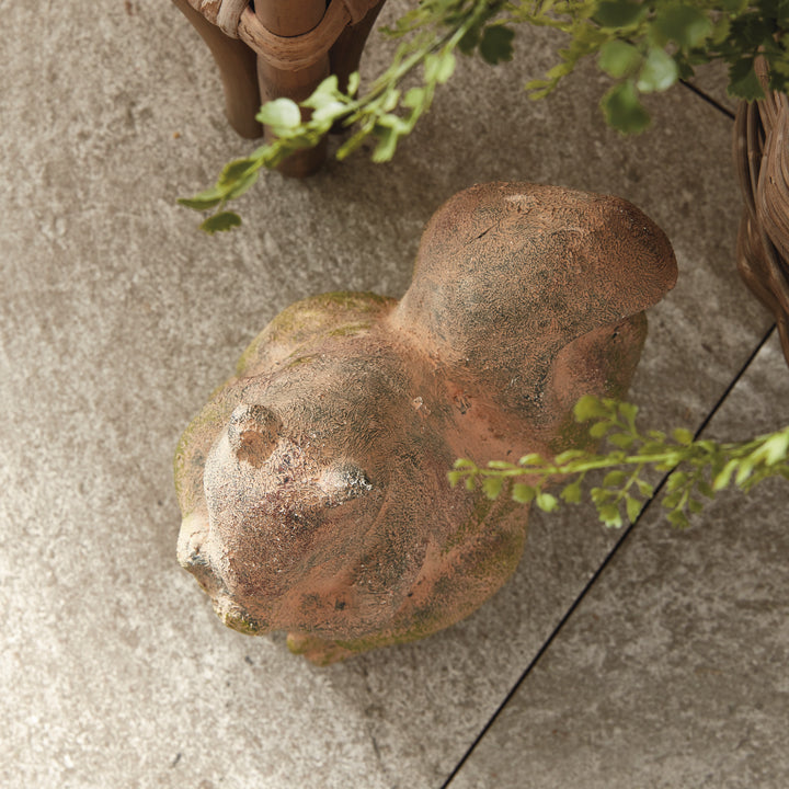 Weathered moss terracotta squirrel garden statue, adding whimsical charm to any outdoor space.