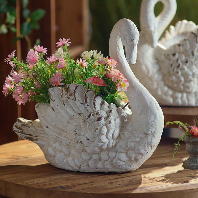 Weathered Swan Garden Planter with raised head and floral arrangement