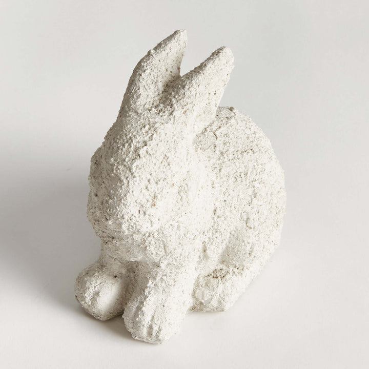 Weathered terracotta bunny garden statue in aged white, perfect for charming outdoor decor.