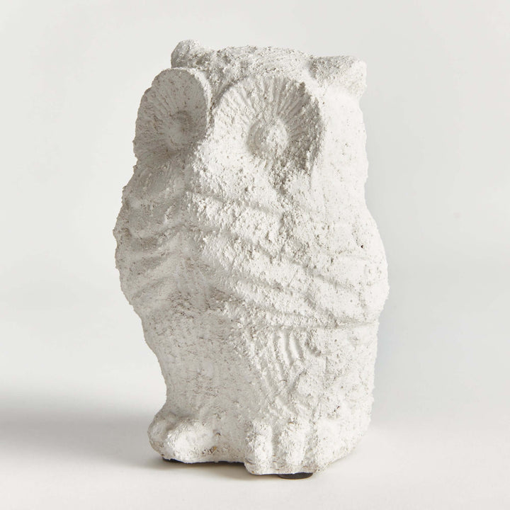 Weathered terracotta owl garden statue in soft whitewash finish, adding charm to outdoor spaces.