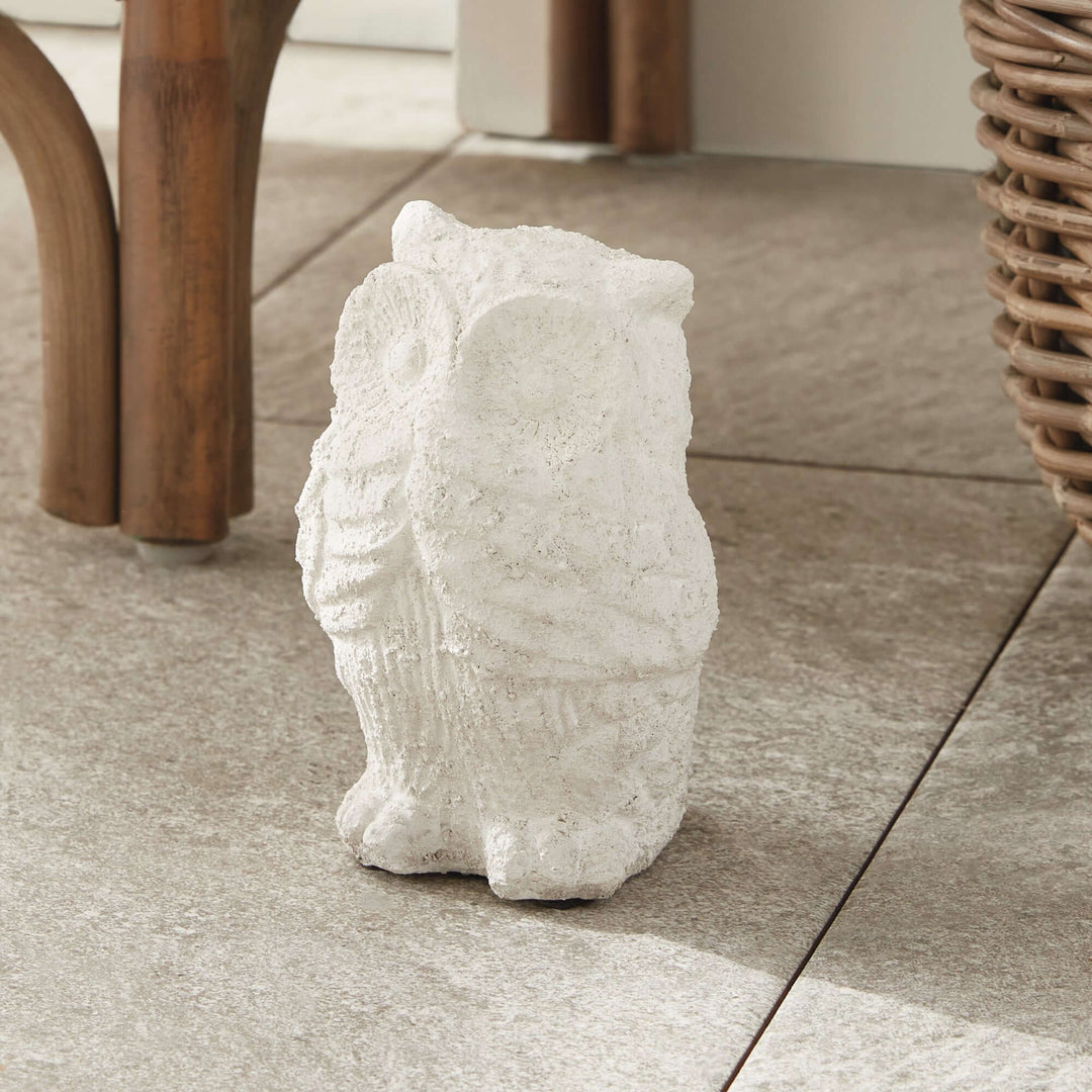 Weathered terracotta owl garden statue in soft whitewash adds charm to outdoor decor.