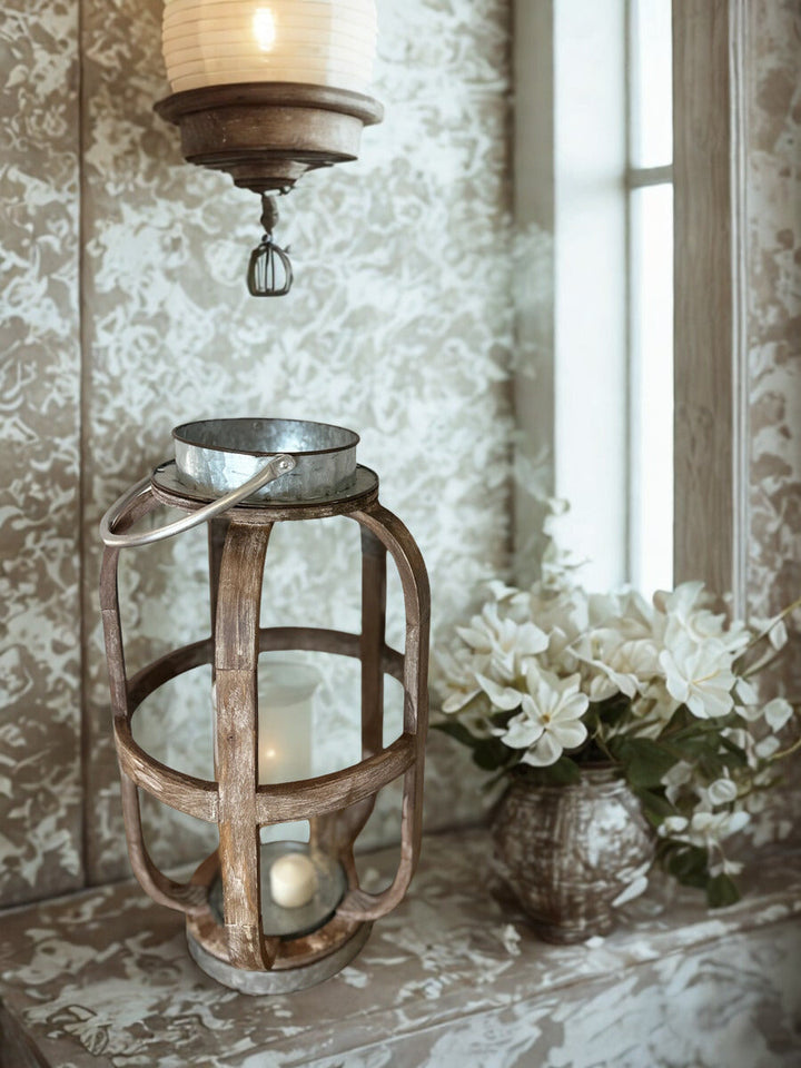 Weathered wood and galvanized metal candle lantern styled beside a sunlit window