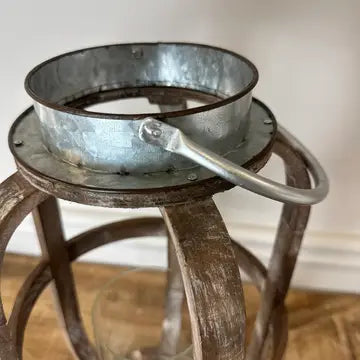 Close view of the galvanized metal collar and loop handle on the wood lantern