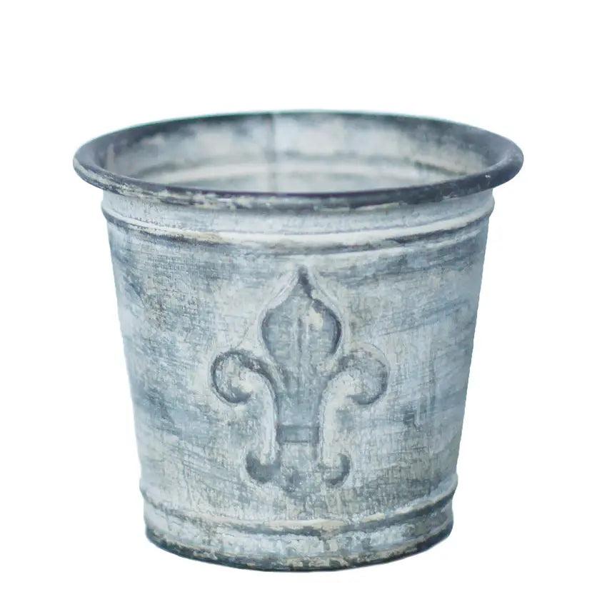 Single weathered zinc flower pot isolated against a white background