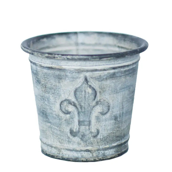 Single weathered zinc flower pot isolated against a white background