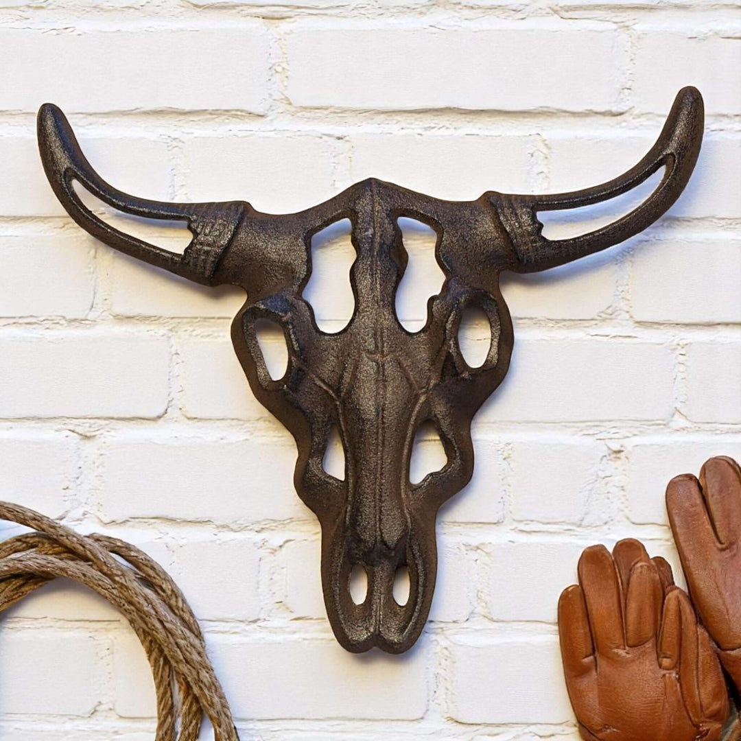 Alt Tag: Western Cast Iron Bull Skull Wall Decor on rustic white brick backdrop.
