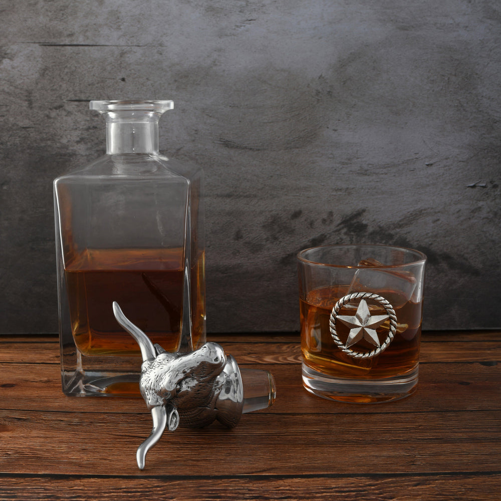 Western Longhorn Whiskey Decanter Set with Glasses featuring metal accents on a rustic wooden table.