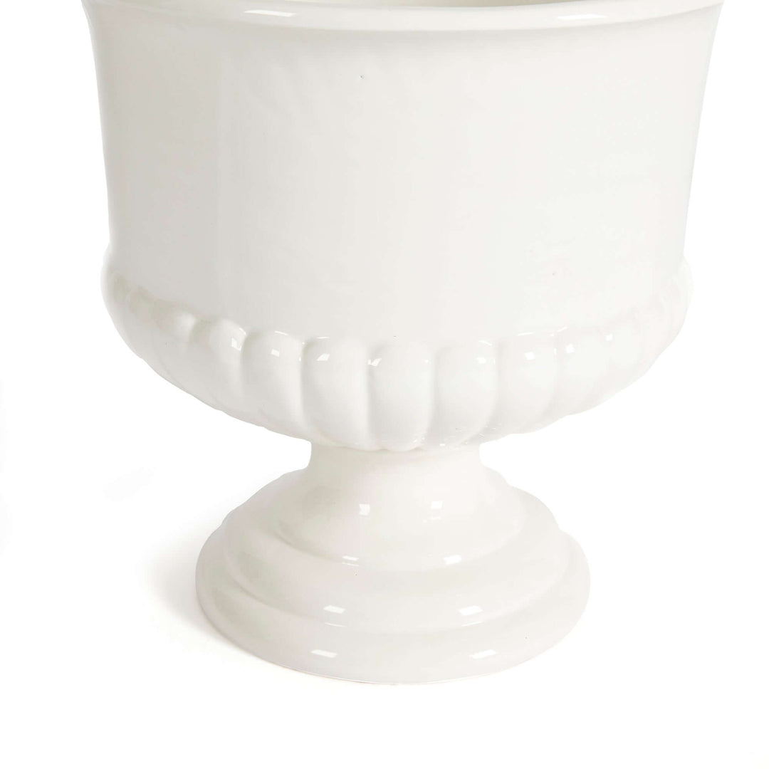 White ceramic urn planter with a pedestal base, perfect for Tuscan-inspired decor, elegantly crafted in soft ivory glaze.