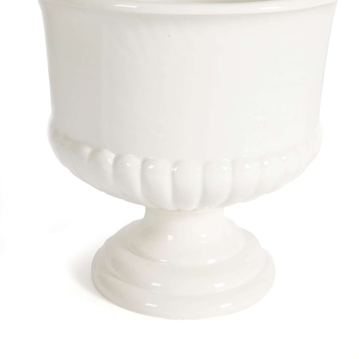 White ceramic urn planter with a pedestal base, perfect for Tuscan-inspired decor, elegantly crafted in soft ivory glaze.