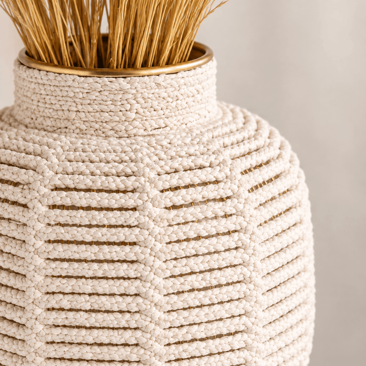 Close-up of white threaded texture and brass-finish rim on the macrame vase