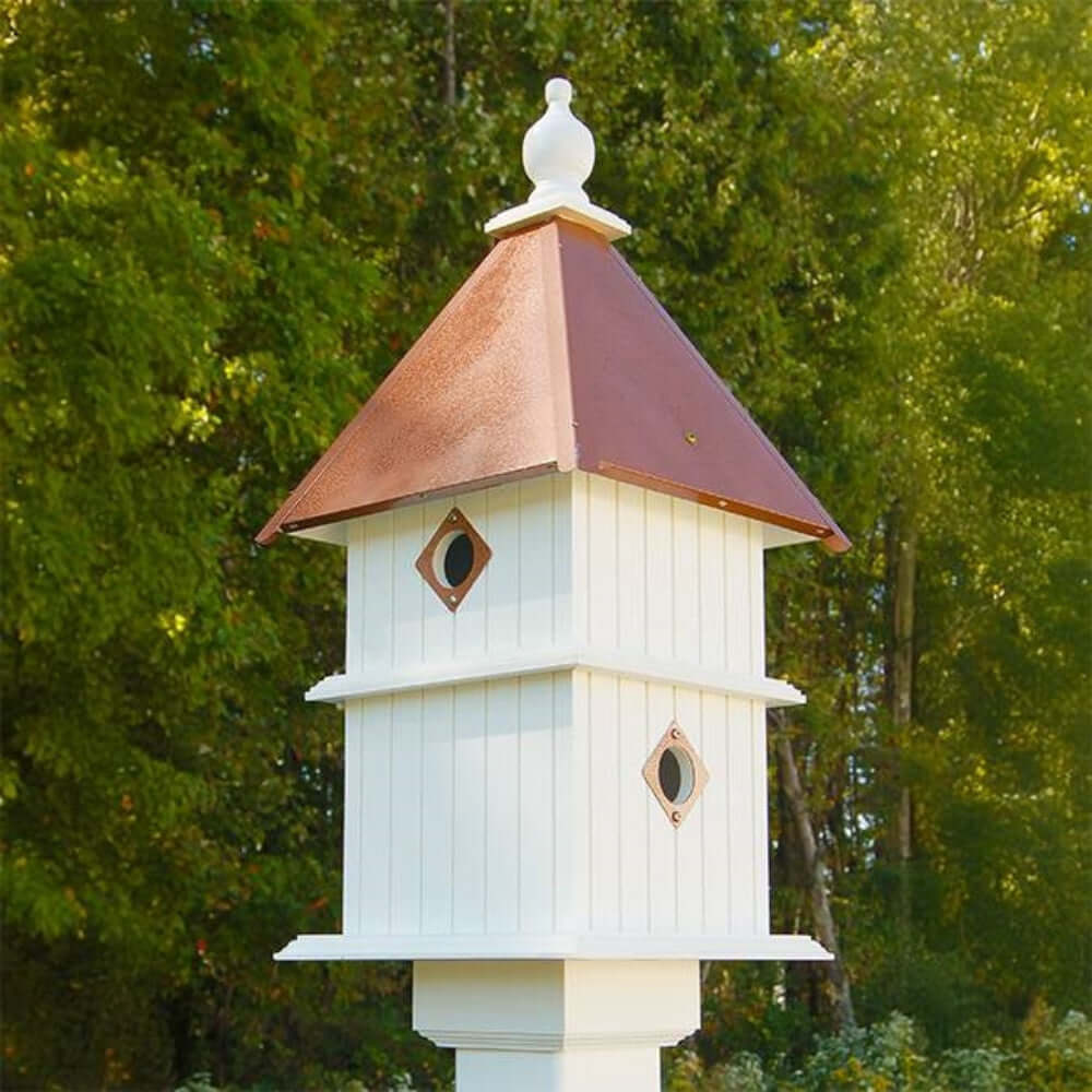White Two Story Birdhouse with Copper Roof in garden setting