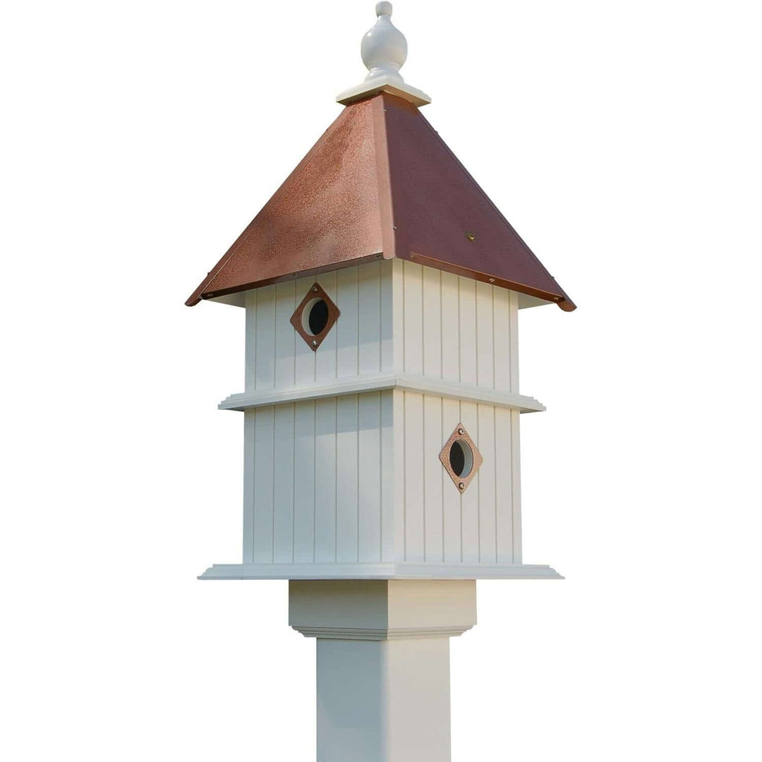 White Two Story Birdhouse with Copper Roof on display against a clear sky