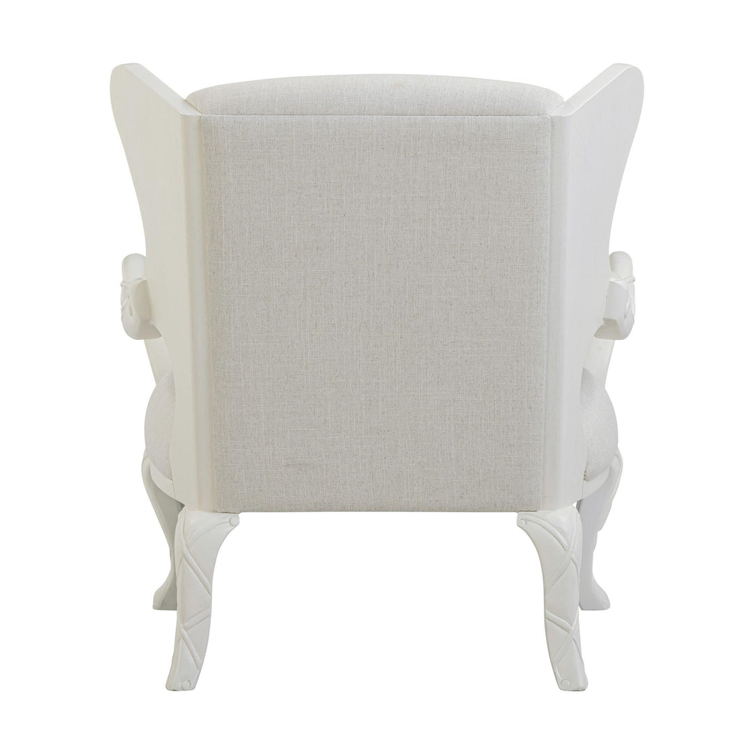 Rear view of the whitewash chair showing the upholstered back and curved legs.