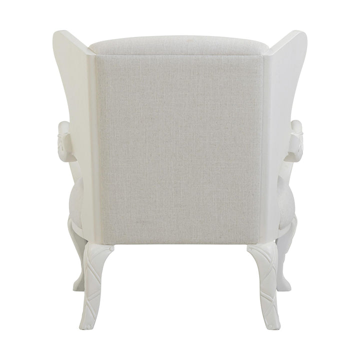 Rear view of the whitewash chair showing the upholstered back and curved legs.