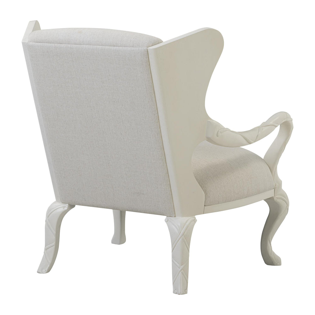 Rear three-quarter view showing the whitewash frame around the ivory upholstered back.