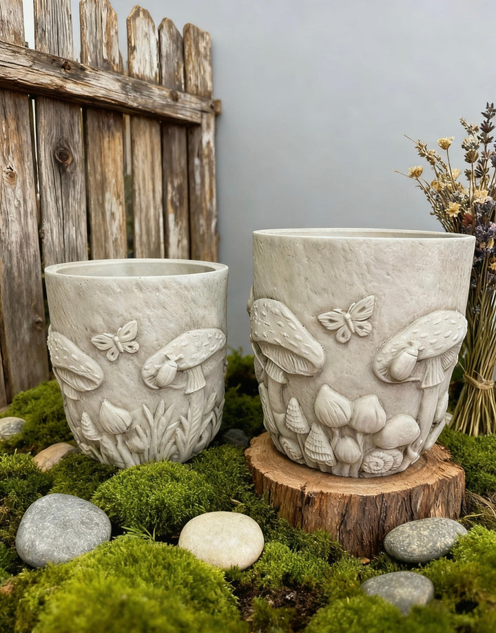 Medium and small Woodland Mushroom and Butterfly Planters in a mossy garden setting